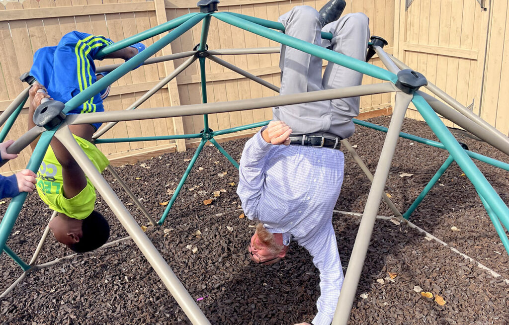 A child and therapist playing outside.