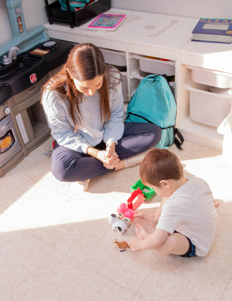 Woman playing on the floor with a child