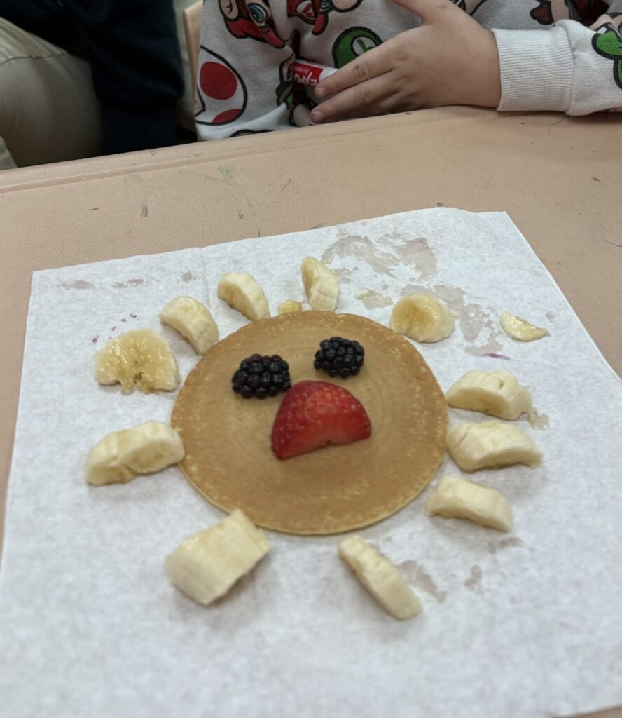 A boy makes a pancake lion